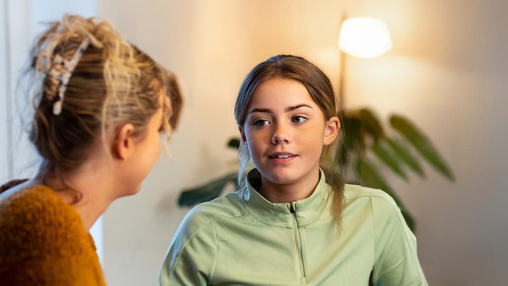 A parent talking to her daughter